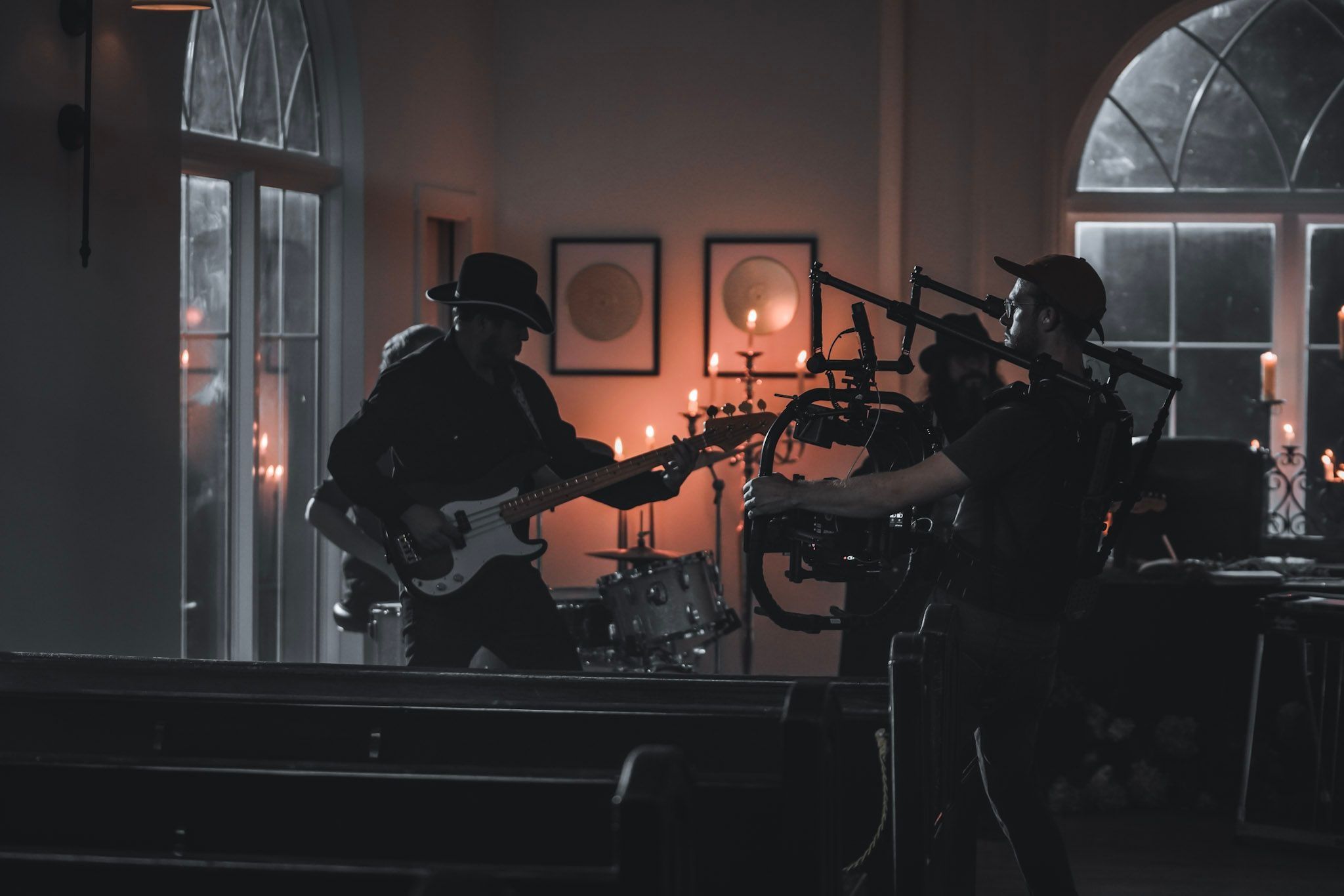 A gimbal operator moves in on a band playing in a candlelit chapel